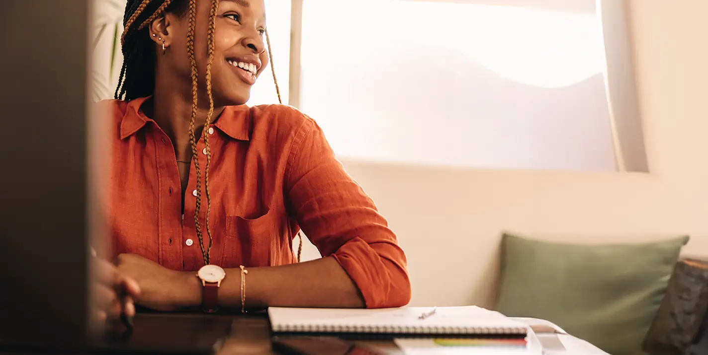 A smiling woman sitting at a desk